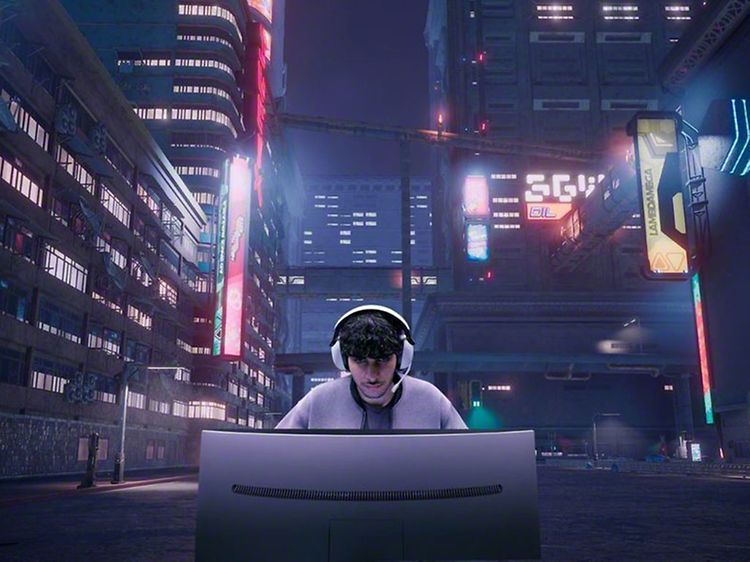 INZONE M9 Gaming Monitor and a boy with headphones behind it